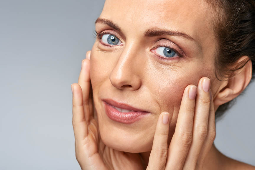 Attractive woman touching her face, mature beauty concept